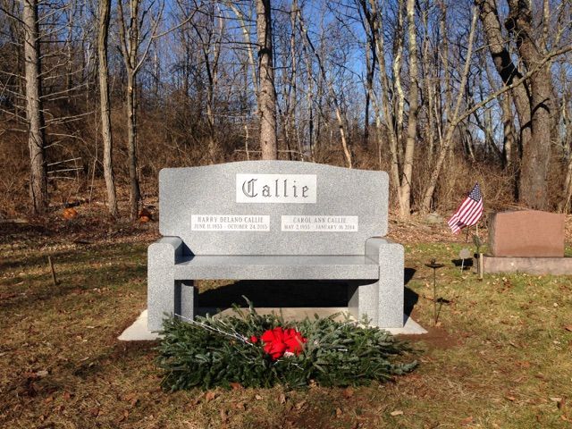 A graveyard with a bench that says callie on it