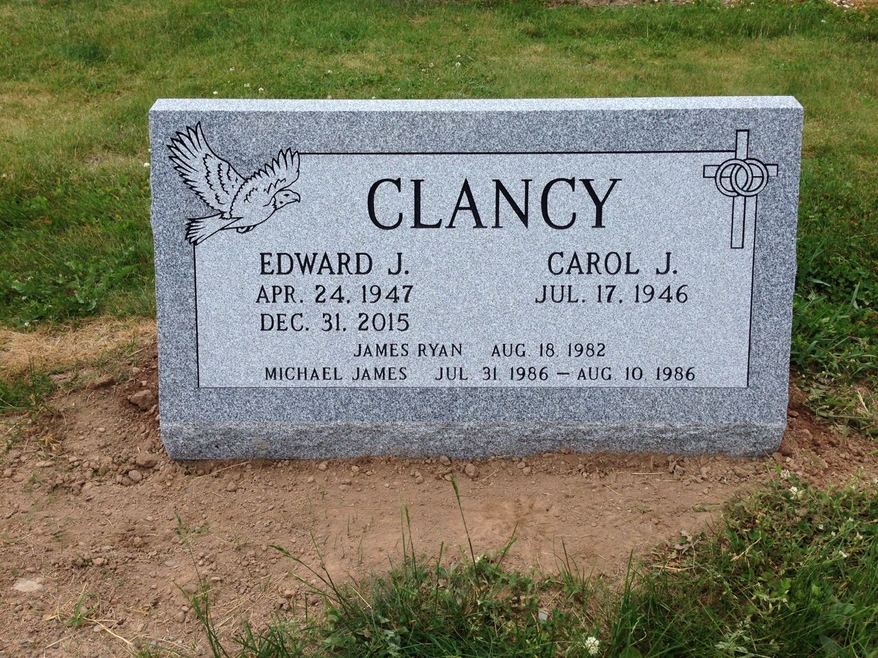 A gravestone for edward j. and carol j. clancy