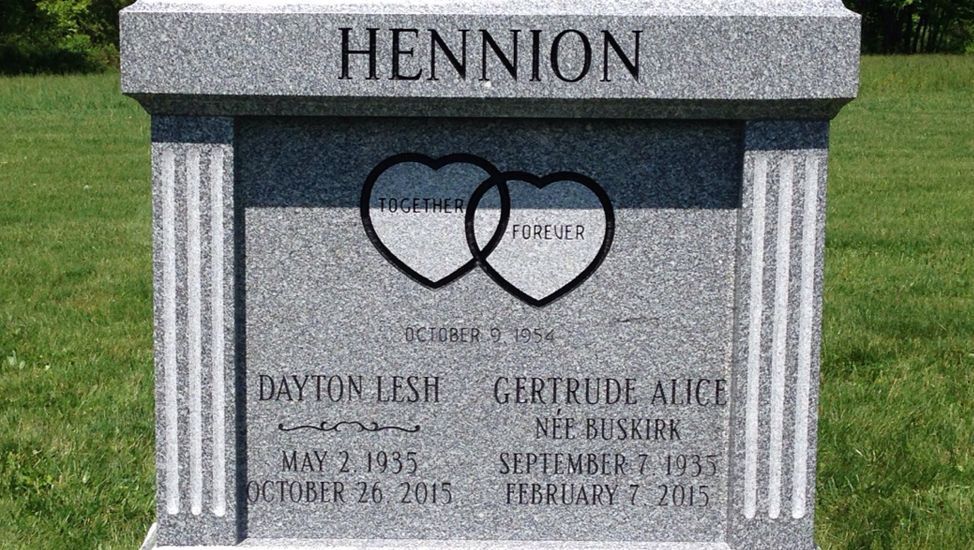 A gravestone with two hearts on it and the name hennion on it.