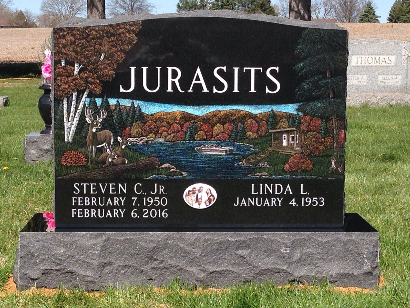A gravestone for steven and linda jura sits in a cemetery