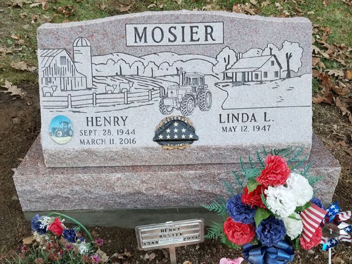 A gravestone for henry and linda mosier with flowers