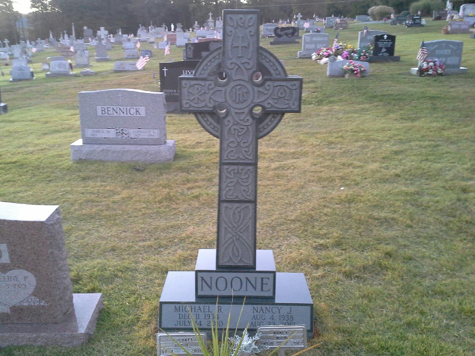 A grave in a cemetery with the name noon on it