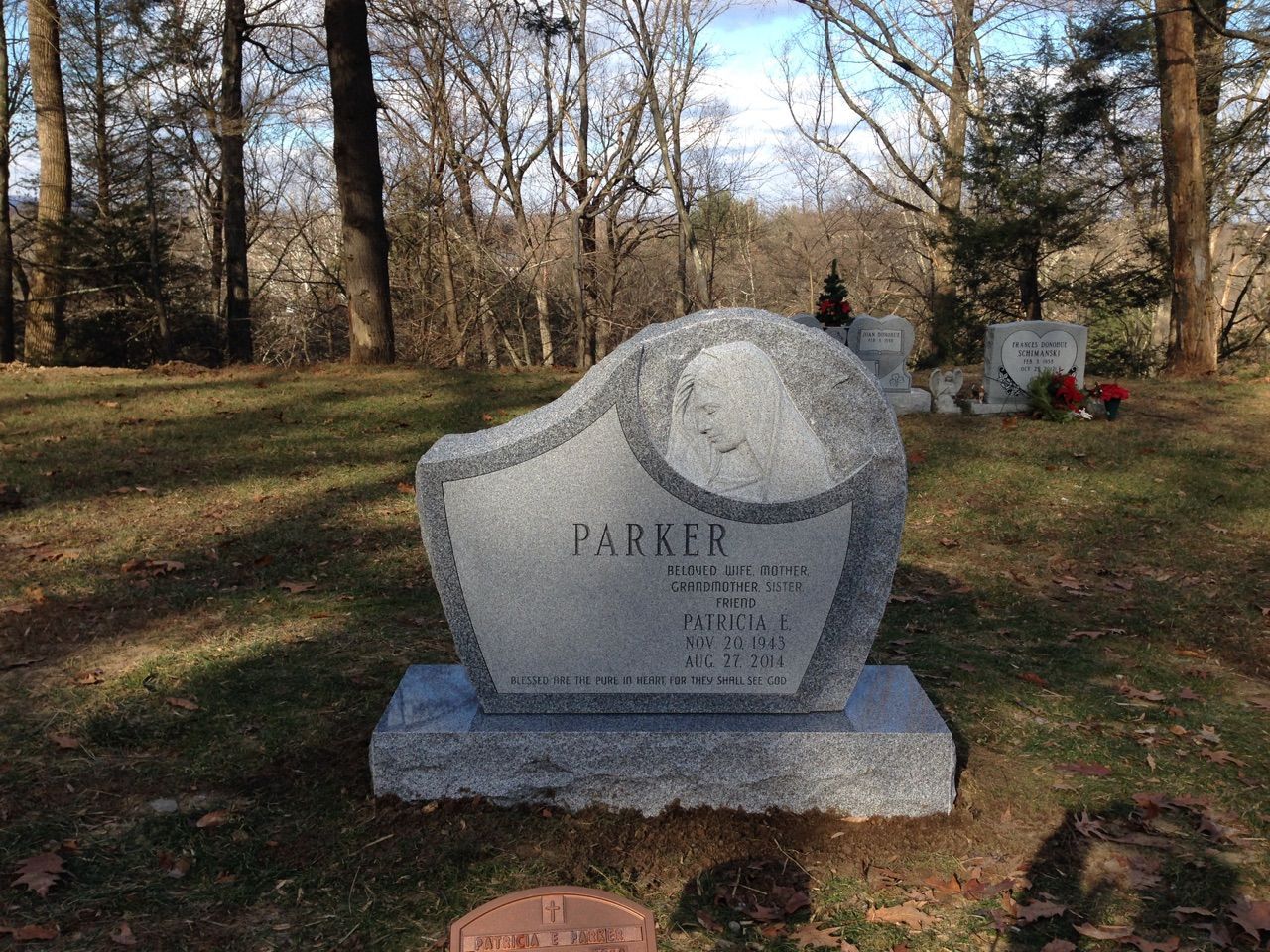 A gravestone in a cemetery with the name parker on it