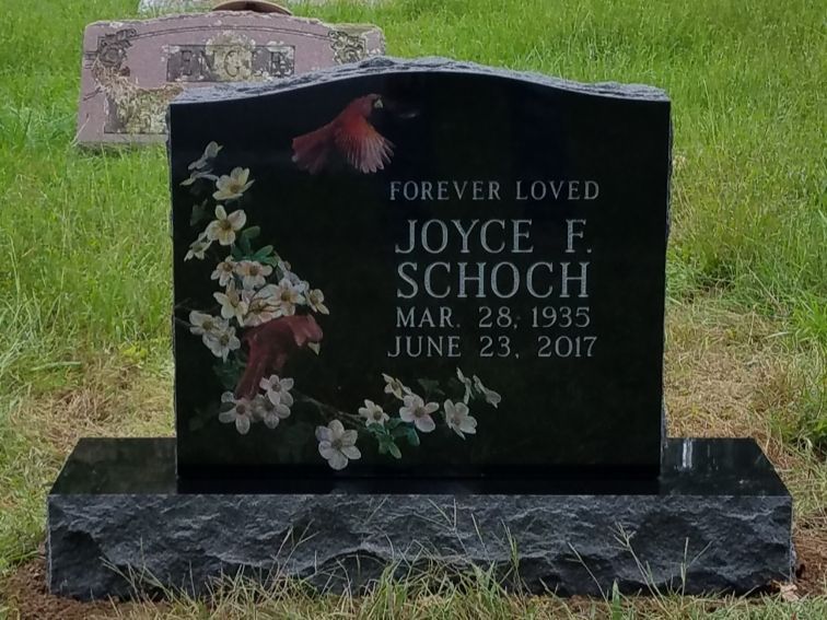 A gravestone for joyce f. schoch is in a cemetery