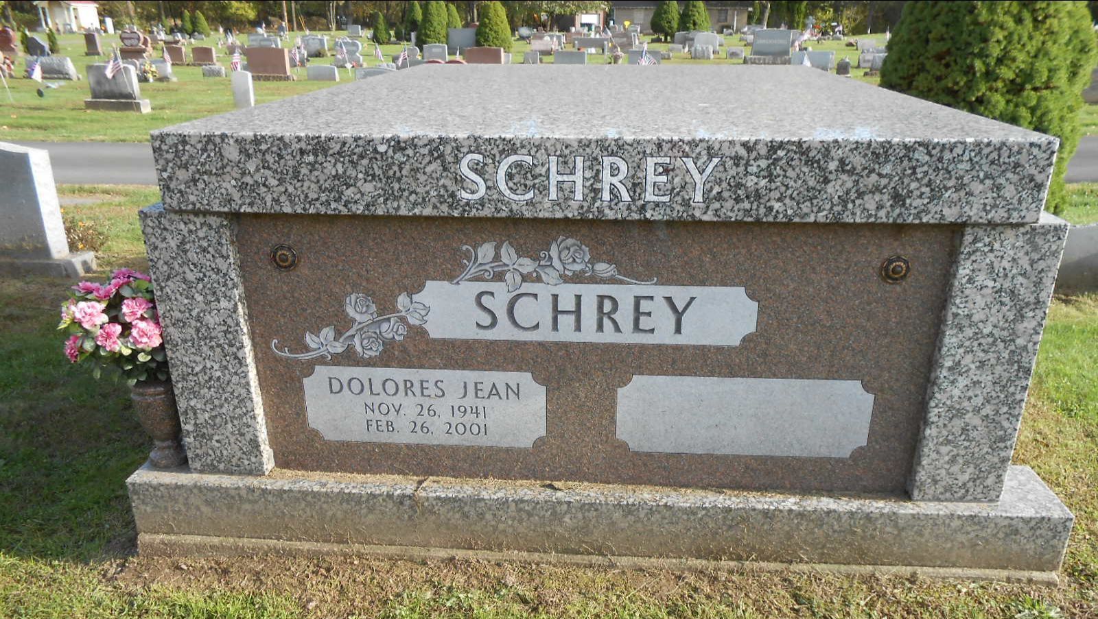 A grave in a cemetery with the name schrey on it