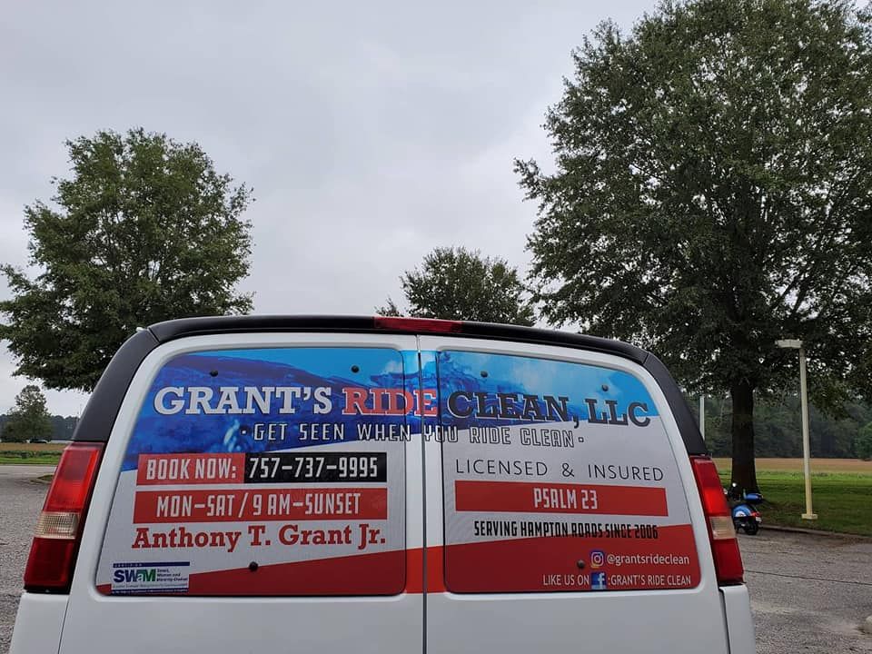 Rear view of a white service van featuring branding for Grant's Ride Clean, LLC, with contact details and business hours.