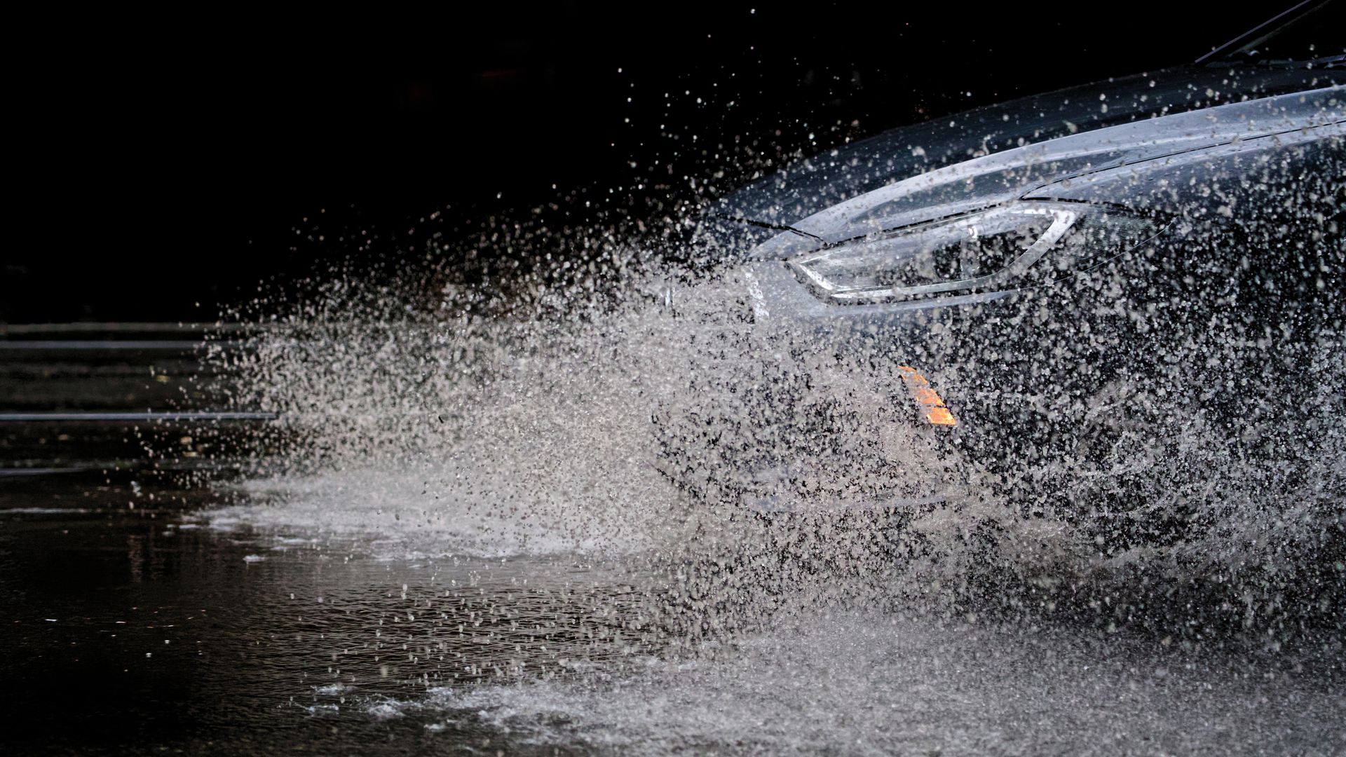 Luxury vehicle driving through high flood water Luxury vehicle driving through high flood water