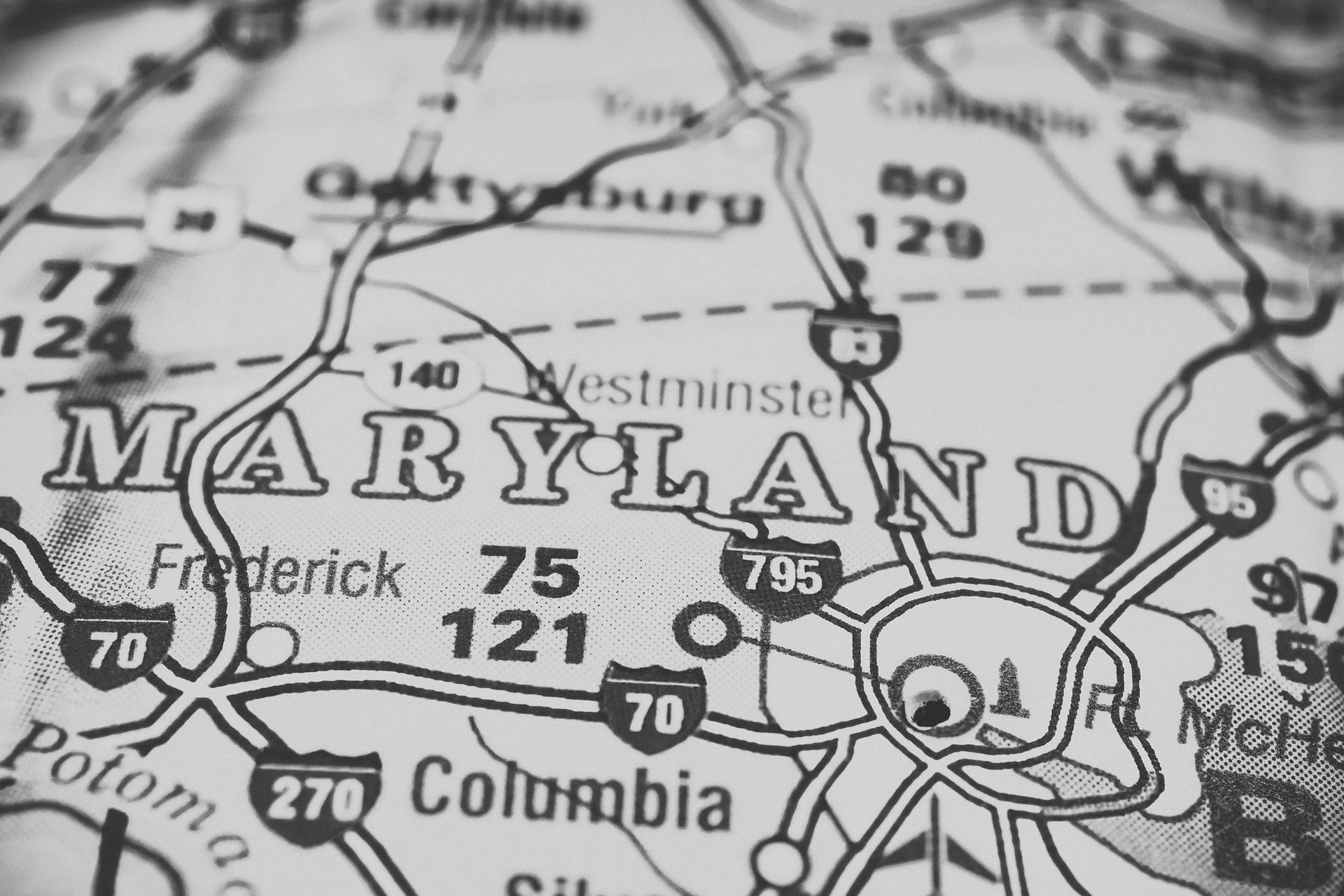 A black and white map of maryland is shown