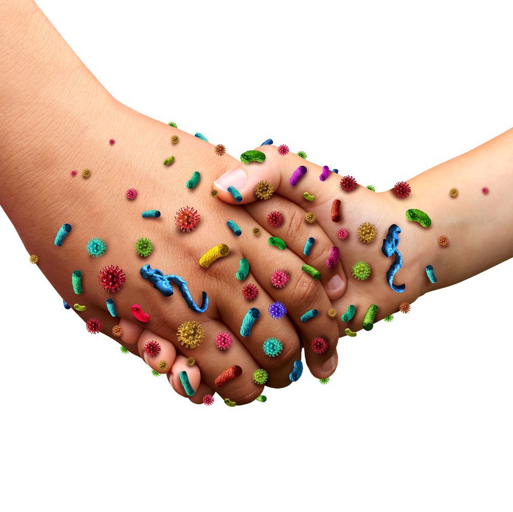 A person shaking hands with bacteria on their hands