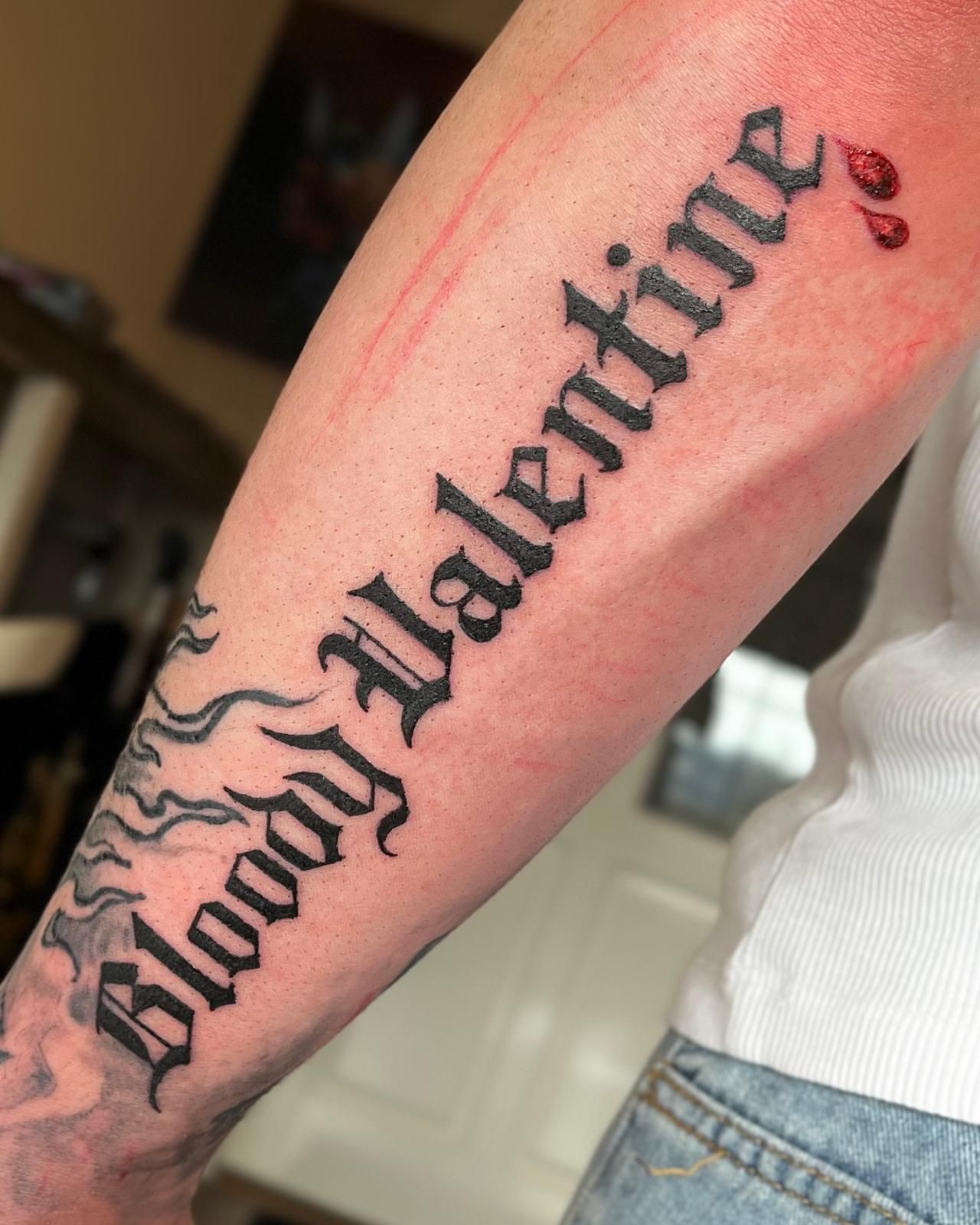 Tattoo op de onderarm met de tekst 