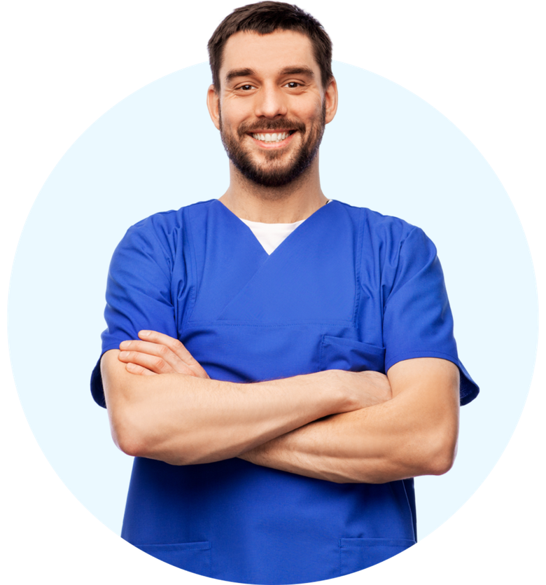 a man in a blue scrub is standing with his arms crossed and smiling .