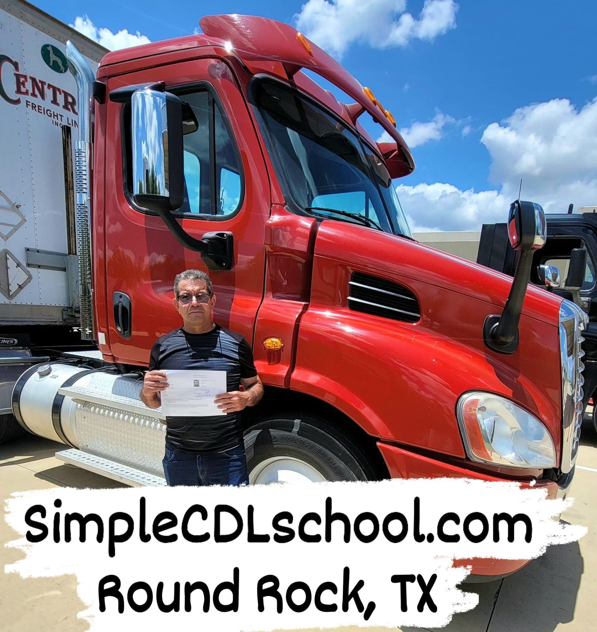A person holding a certificate in front of a large, bright red semi-truck at SimpleCDLschool.com in Round Rock, TX.