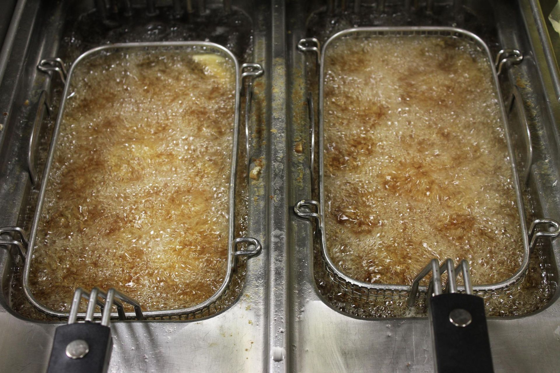 two metal pans filled with food on top of a stove
