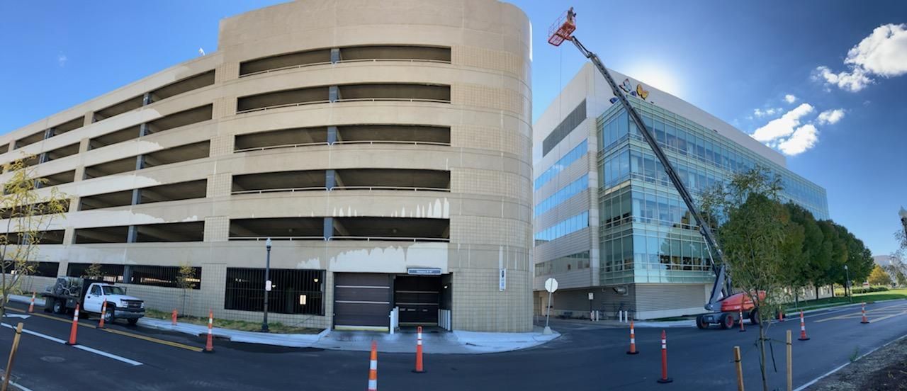 A large building with a crane in front of it.