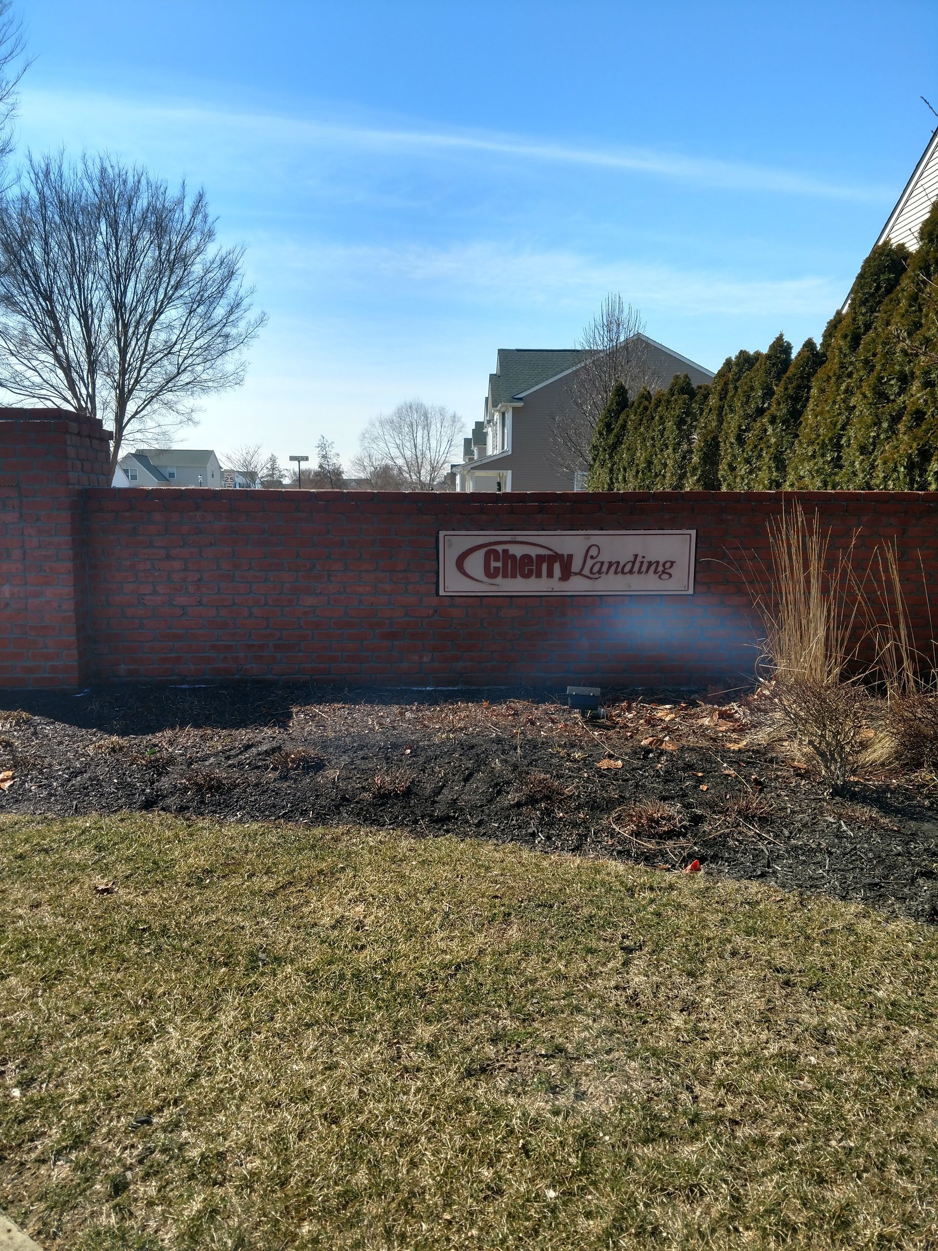 A brick wall with a sign that says cherry groves on it