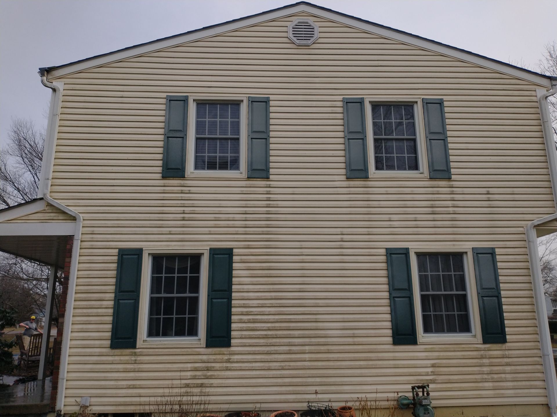 A house with a lot of windows and green shutters