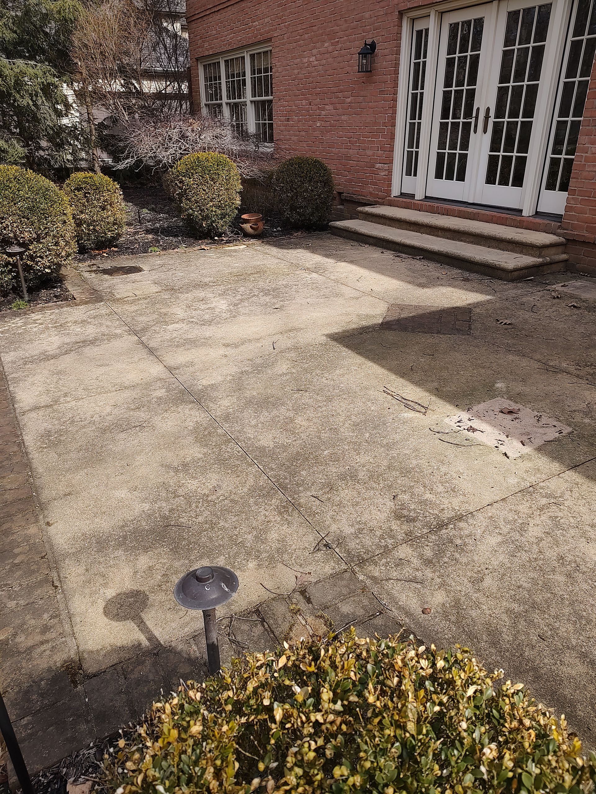 A brick house with a patio in front of it.