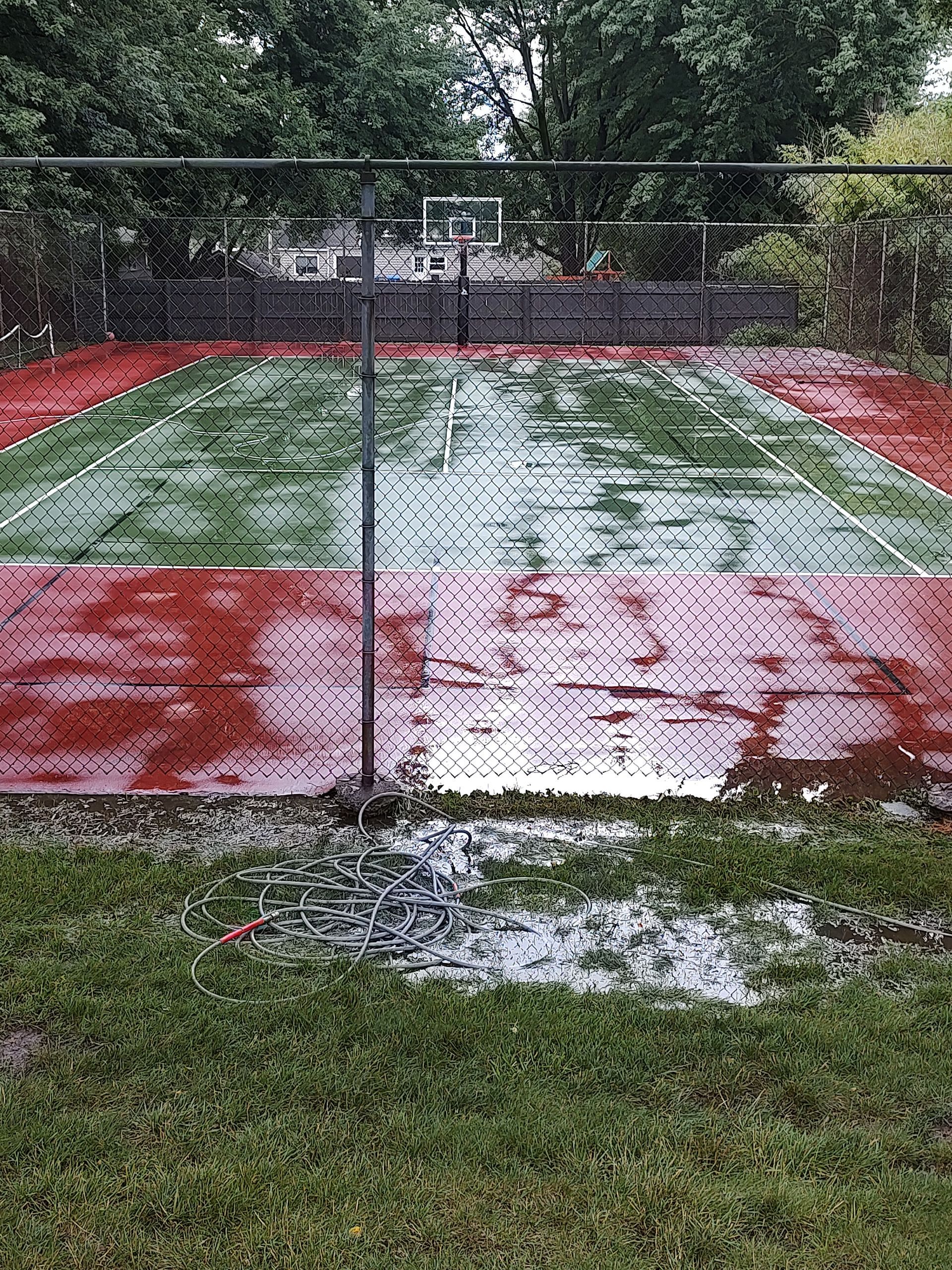 A volleyball court is covered in water after a rain storm.
