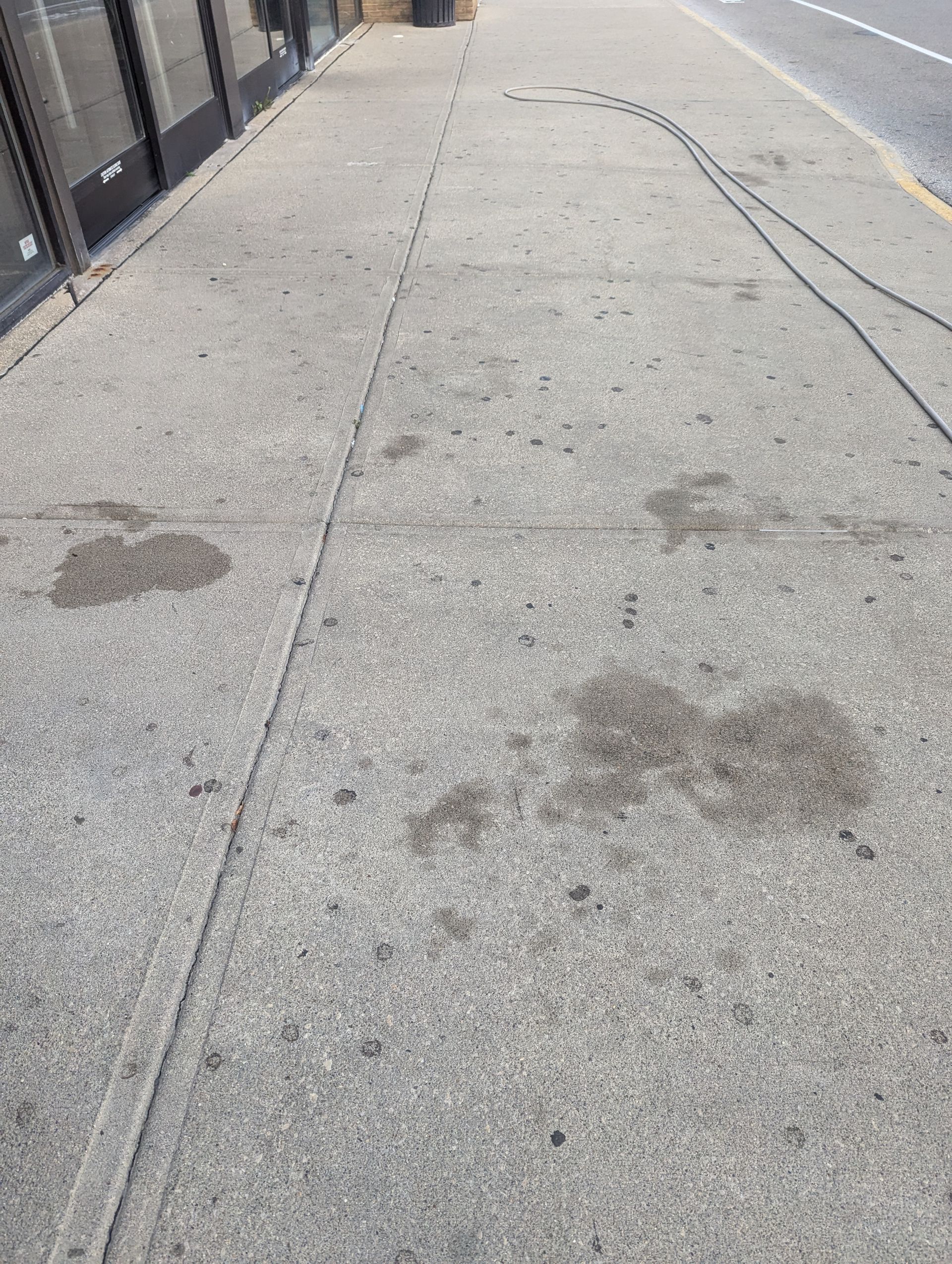 A sidewalk with a lot of stains on it.