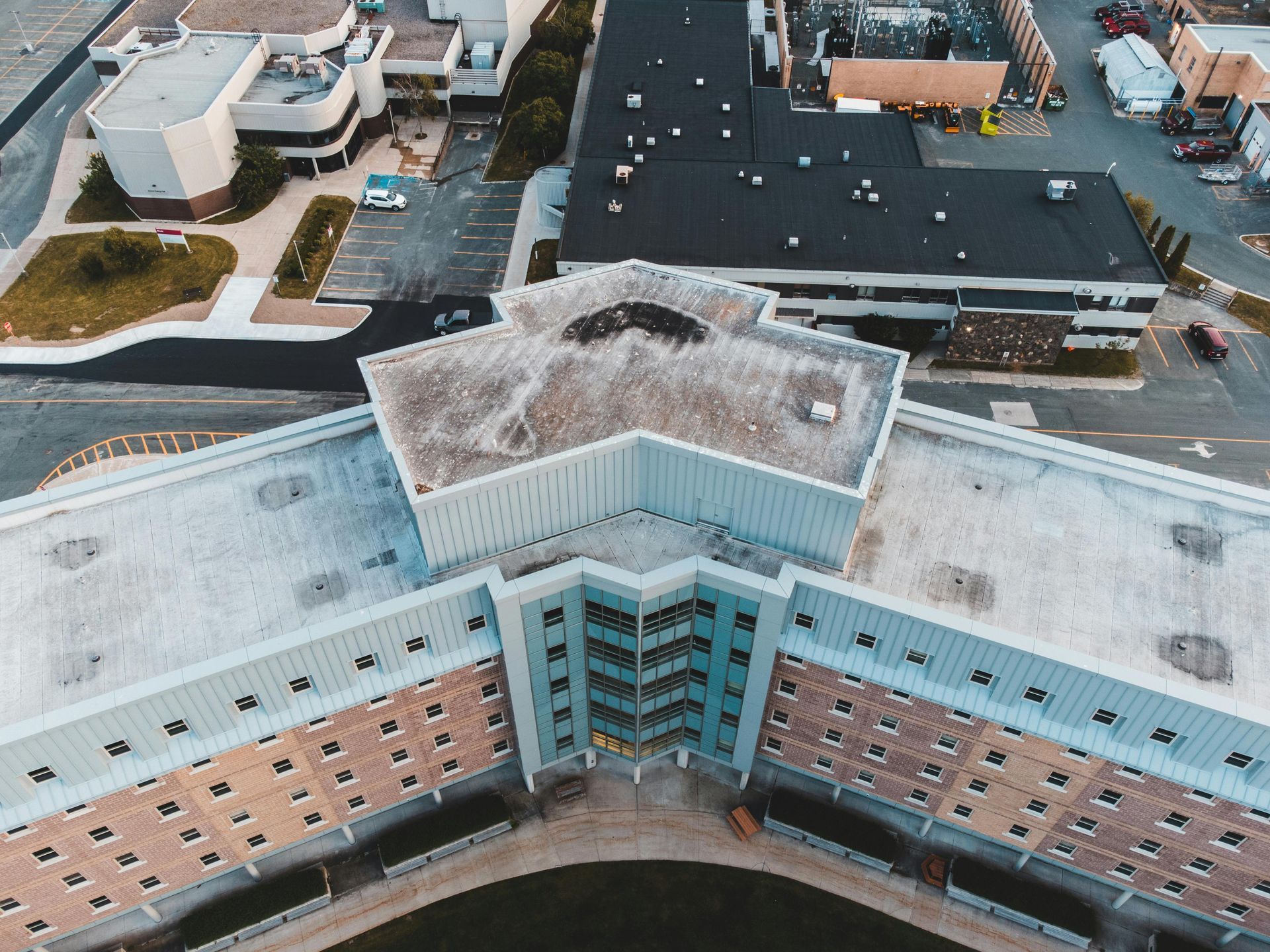 An aerial view of a large building with a hole in the roof