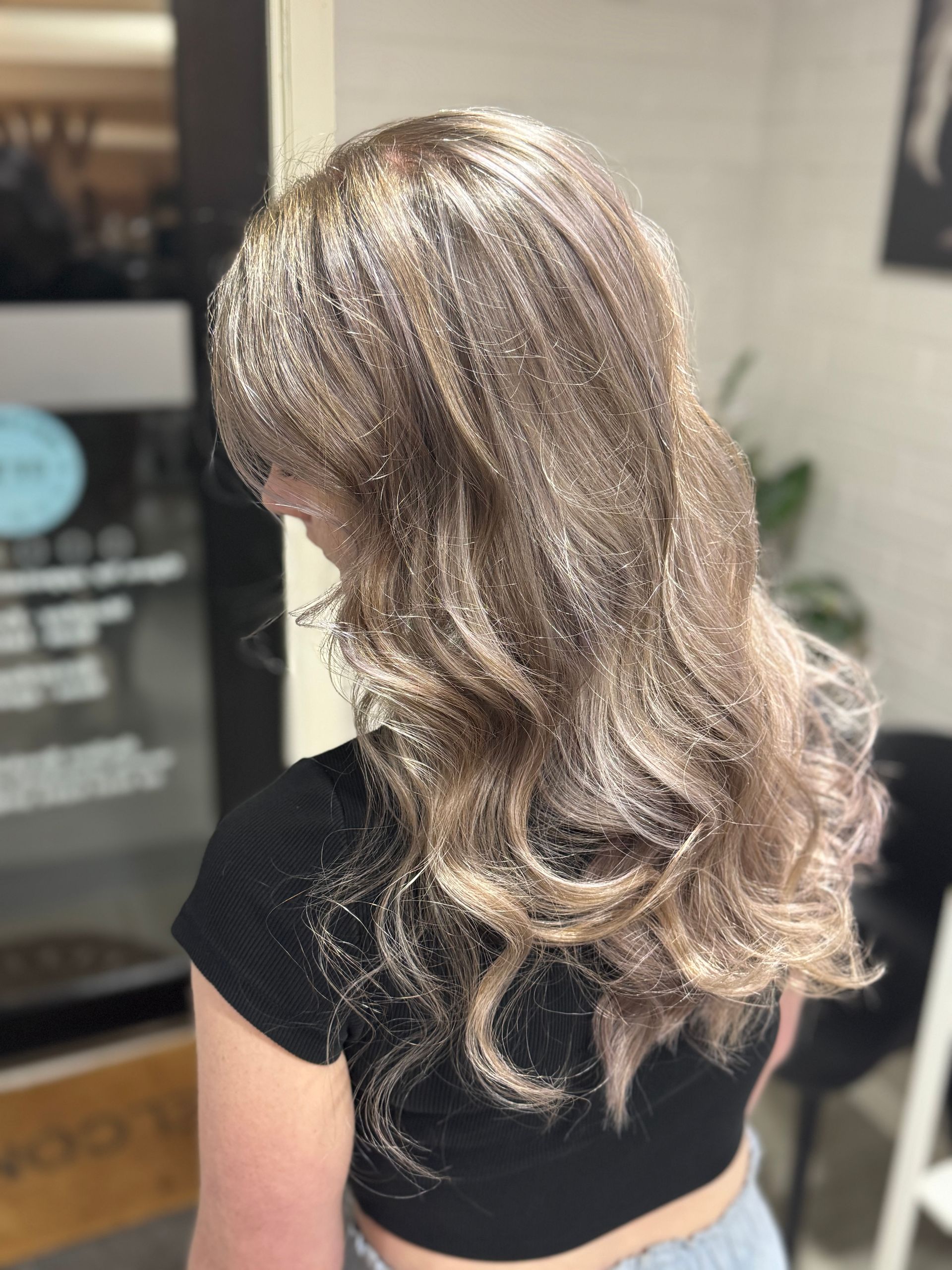 Woman with wavy, ash blonde hair. Wow! Excellence in Hair in Toowoomba, QLD