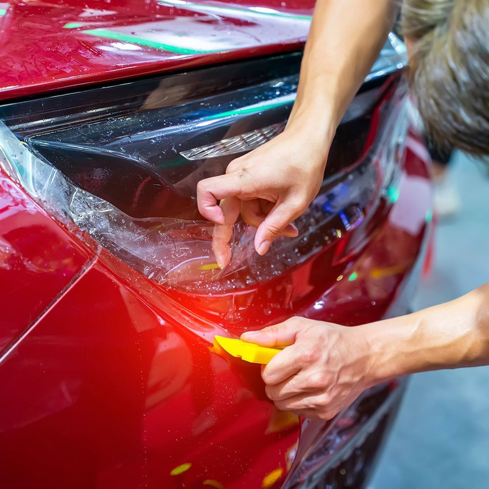 Installing Paint Protection On Red Car — Miramar, FL — Oscar Tint Solutions Installing Paint Protection On Red Car — Miramar, FL — Oscar Tint Solutions