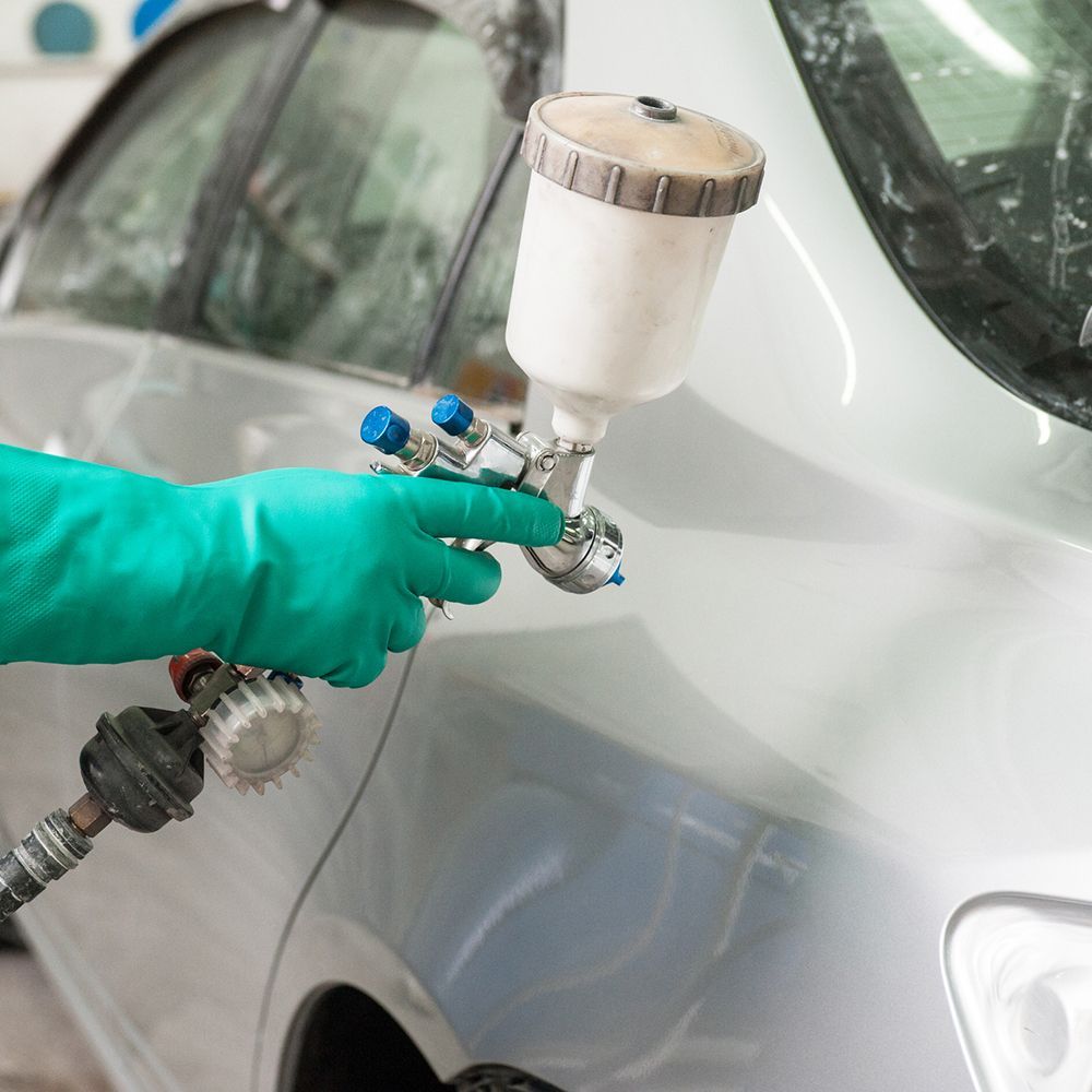 Using Spray To Paint A Car — Miramar, FL — Oscar Tint Solutions Using Spray To Paint A Car — Miramar, FL — Oscar Tint Solutions
