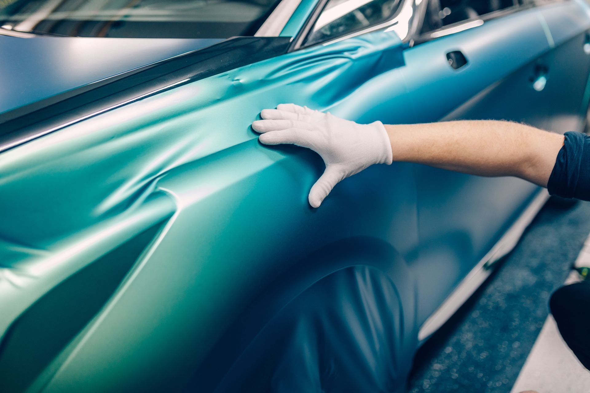 Applying Car Wrap — Miramar, FL — Oscar Tint Solutions Applying Car Wrap — Miramar, FL — Oscar Tint Solutions