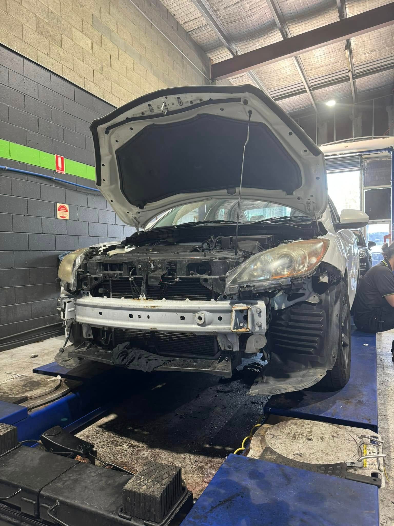 Damaged SUV On A Lift In An Auto Repair Shop — Mr Mechanical Auto Service Centre in Southport, QLD
