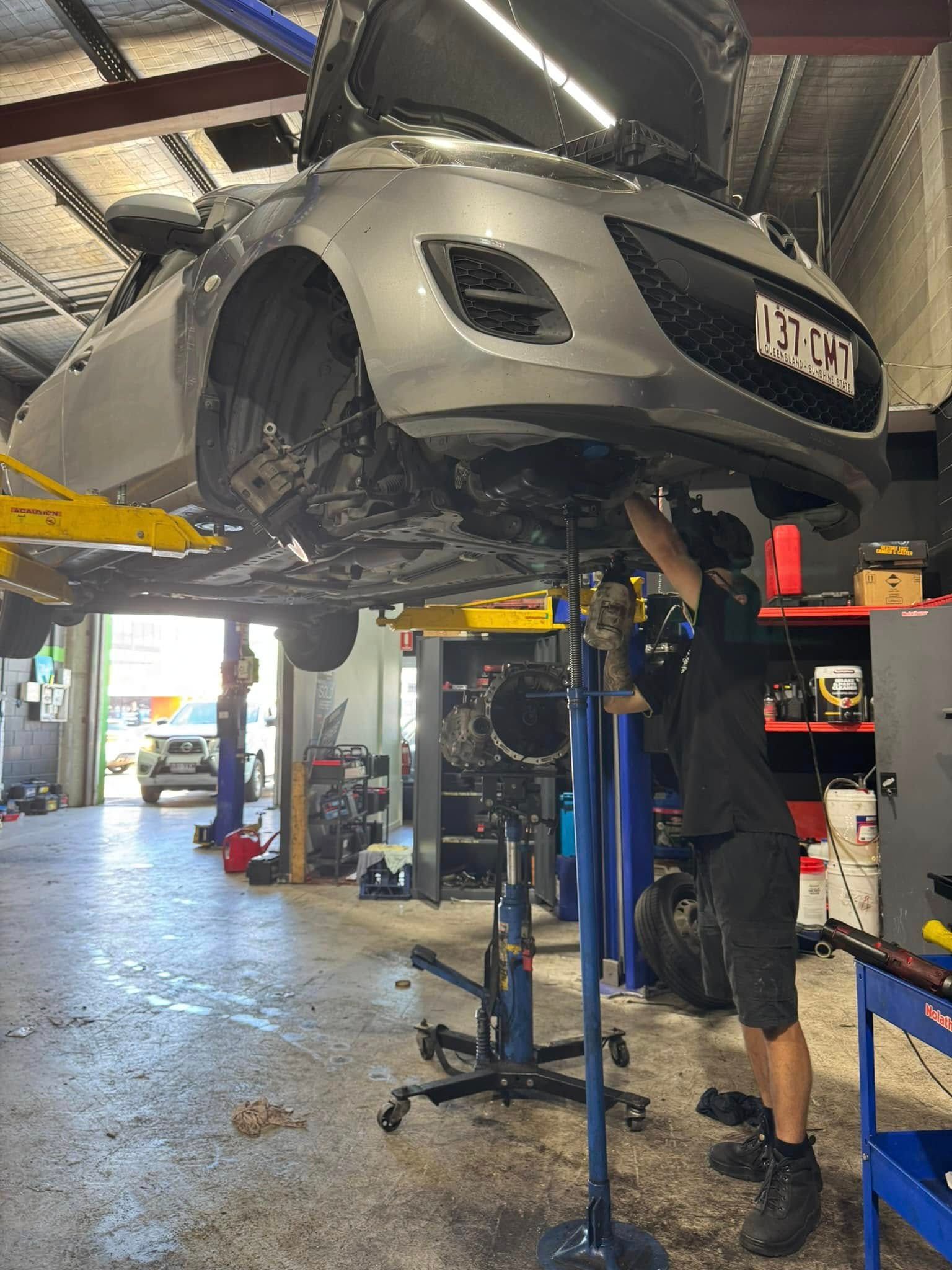 Car Lifted On A Garage Hoist — Mr Mechanical Auto Service Centre in Southport, QLD