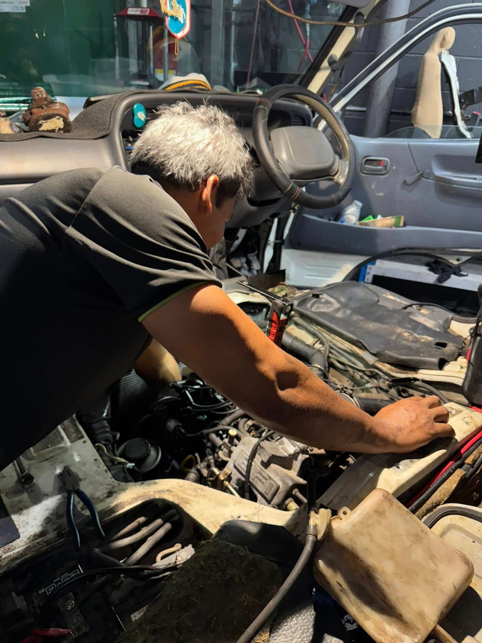 Mechanic Working Under The Hood Of A Blue Car — Mr Mechanical Auto Service Centre in Southport, QLD