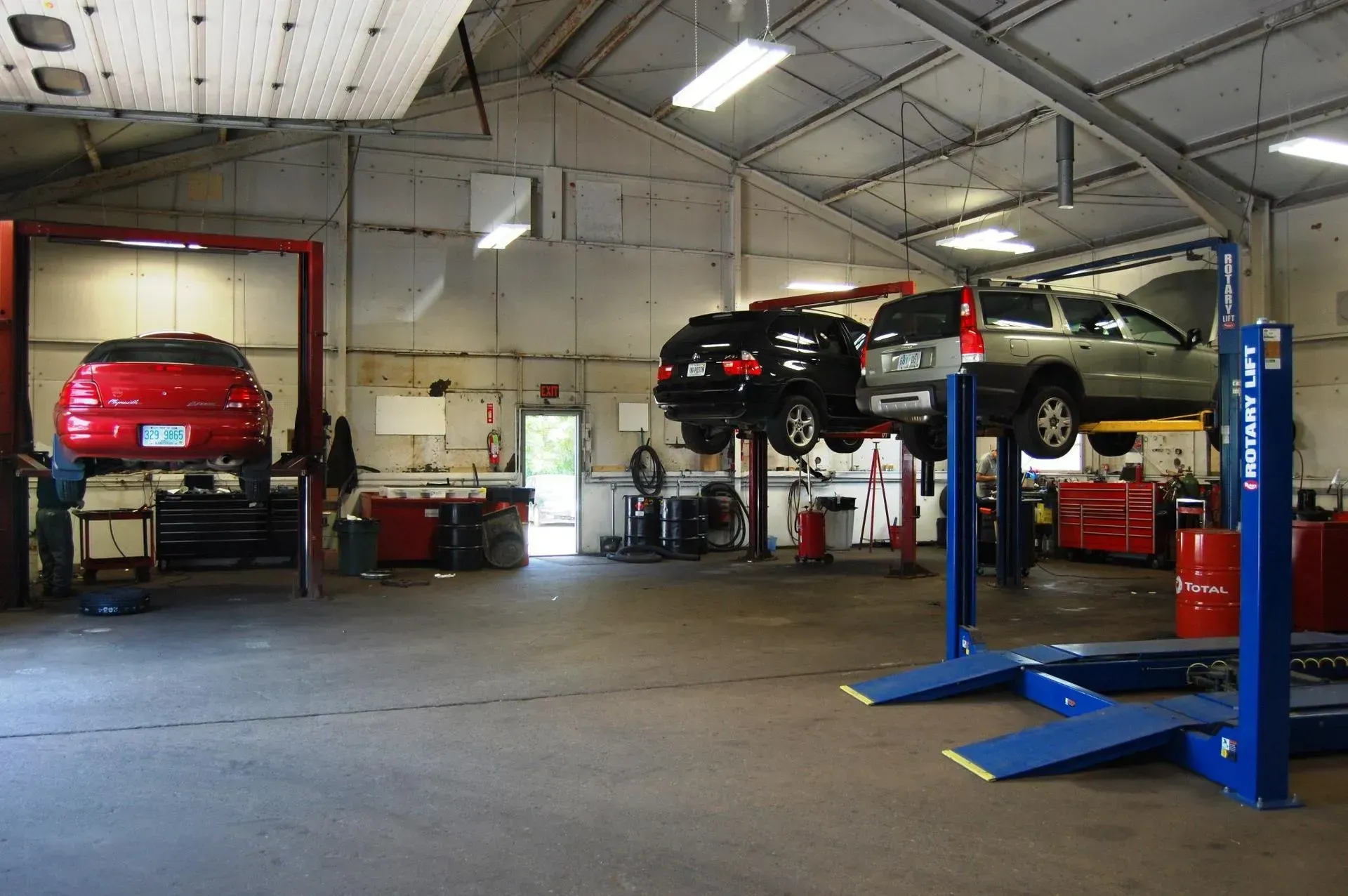 Multiple Vehicles On Lifts Inside Fleet Repair Shop | Garry's Service Center