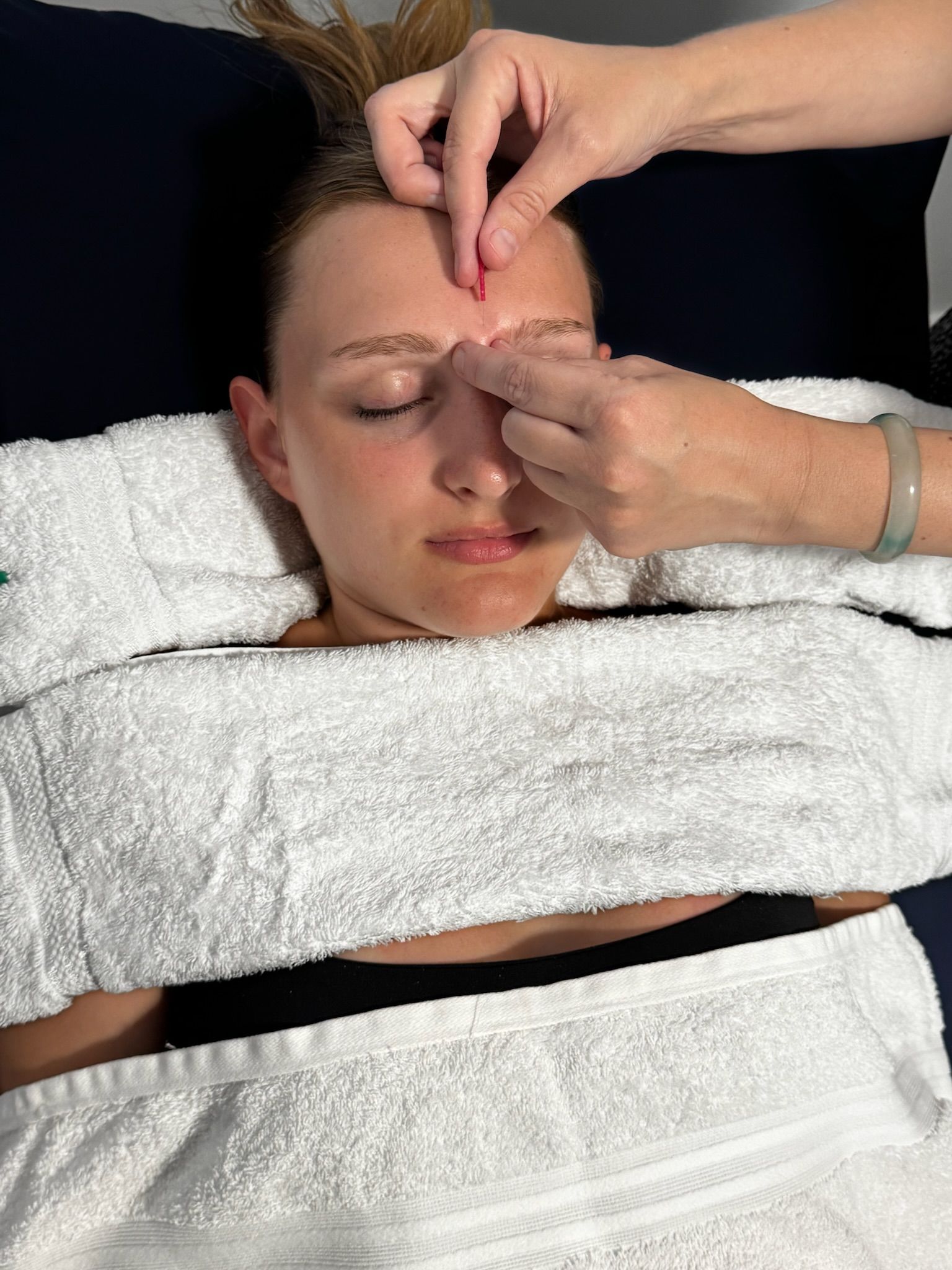 A Man Is Giving A Woman A Massage On A Table — Resonance Health Studio in Wauchope, NSW