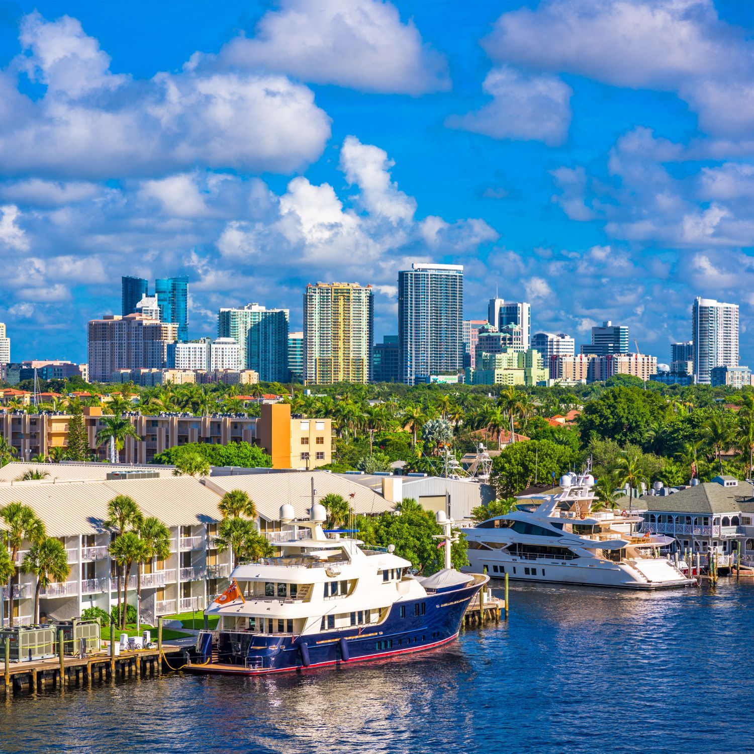 A boat is docked in front of a city skyline