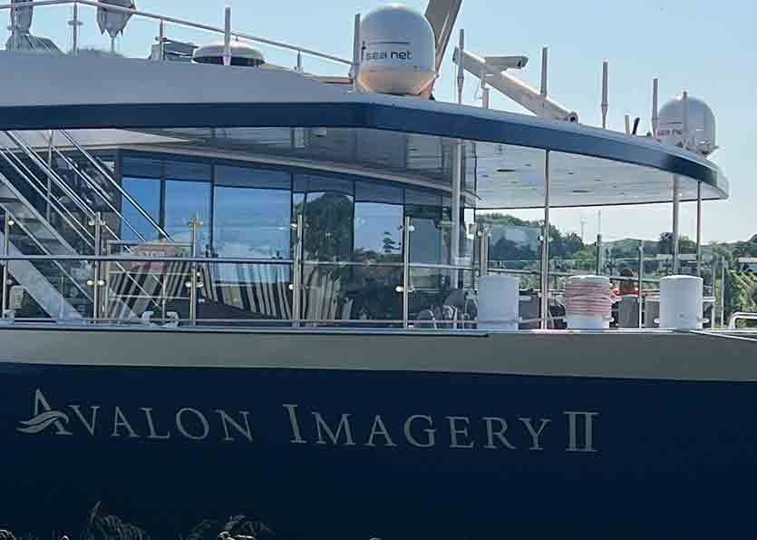 Avalon Imagery II boat docked, with glass windows and white upper deck visible.