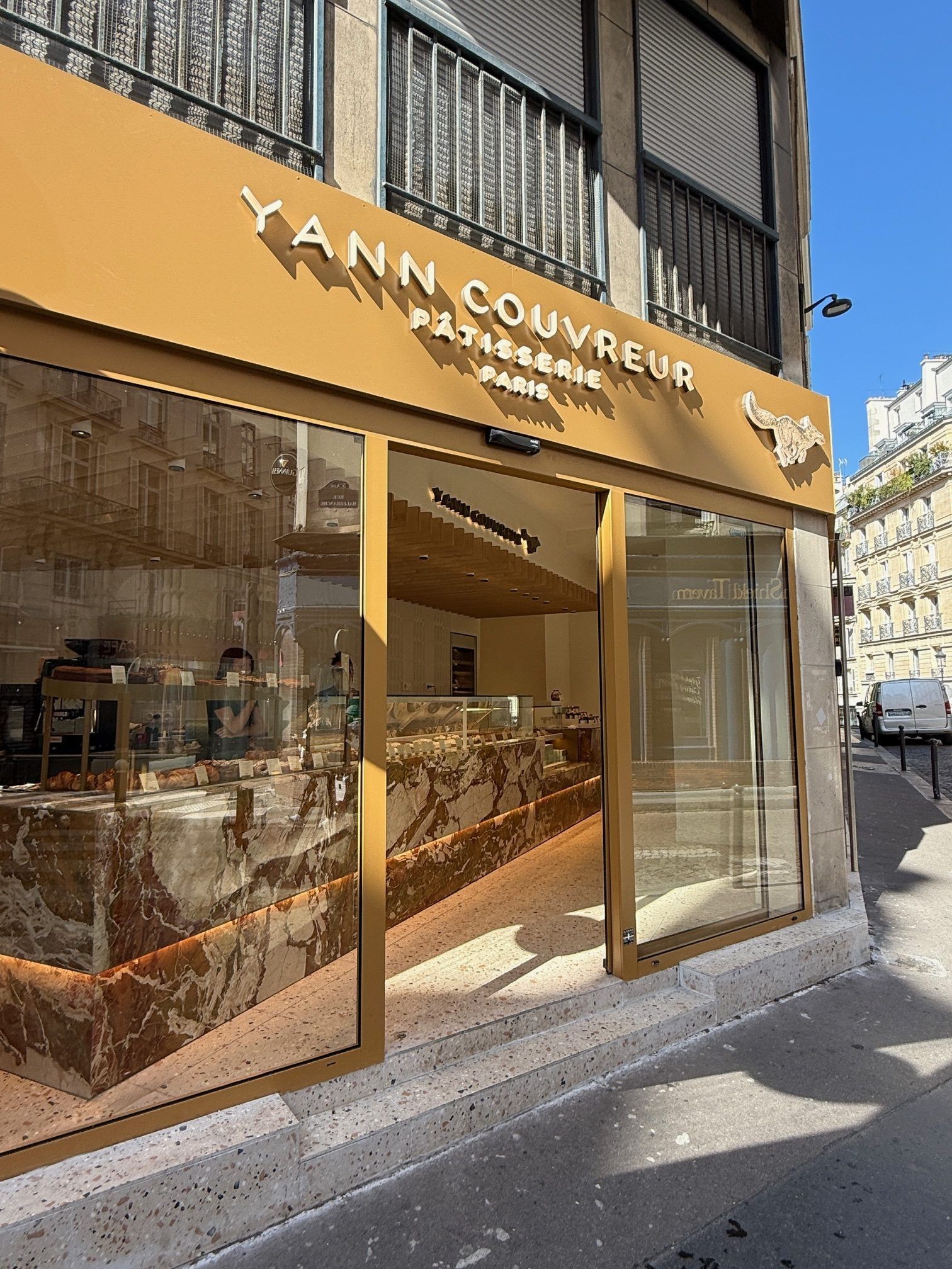YANN COUVREUR bakery storefront with glass windows and gold sign on a snowy street