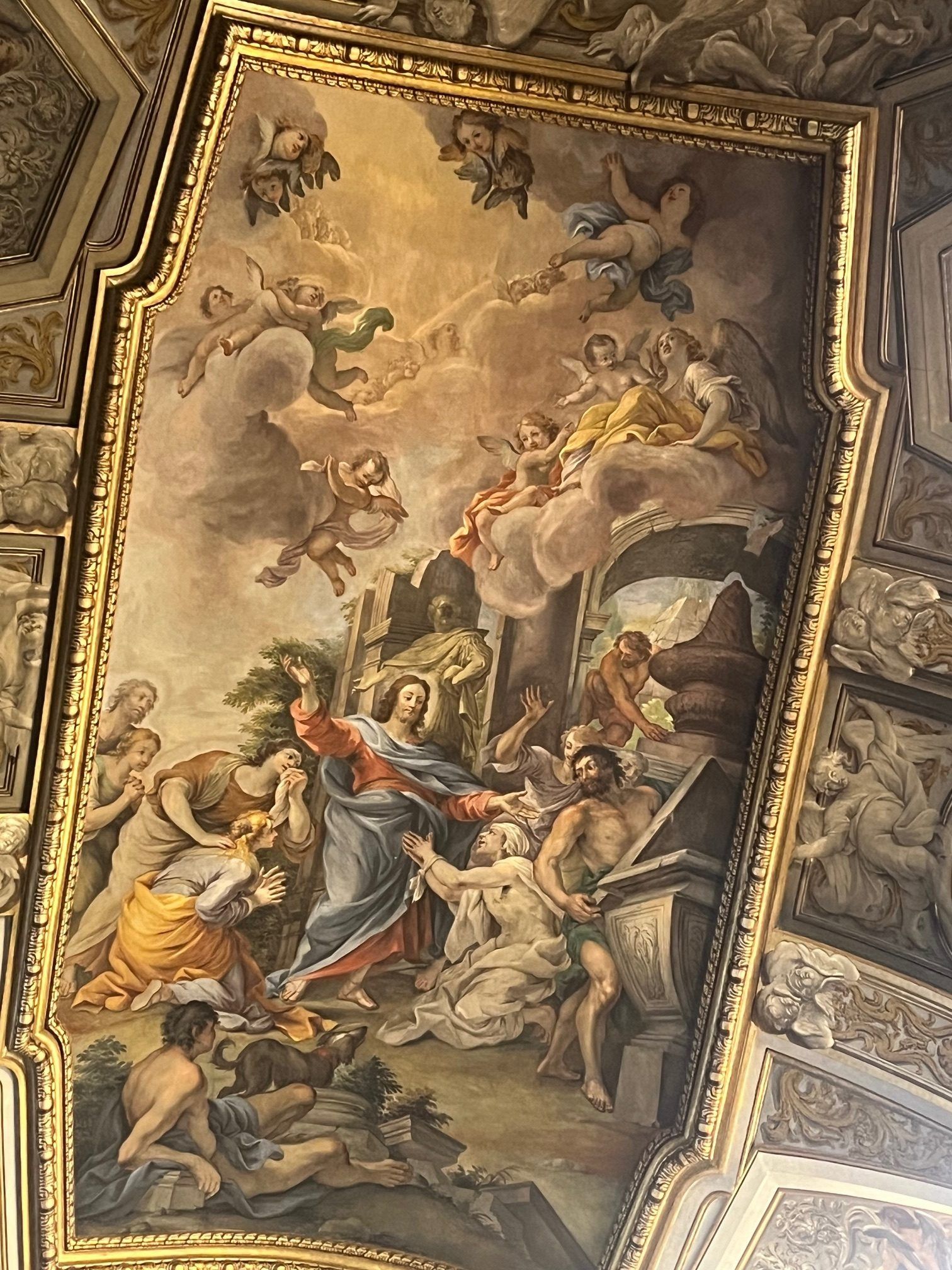 Baroque ceiling fresco with angels and robed figures around a radiant central scene