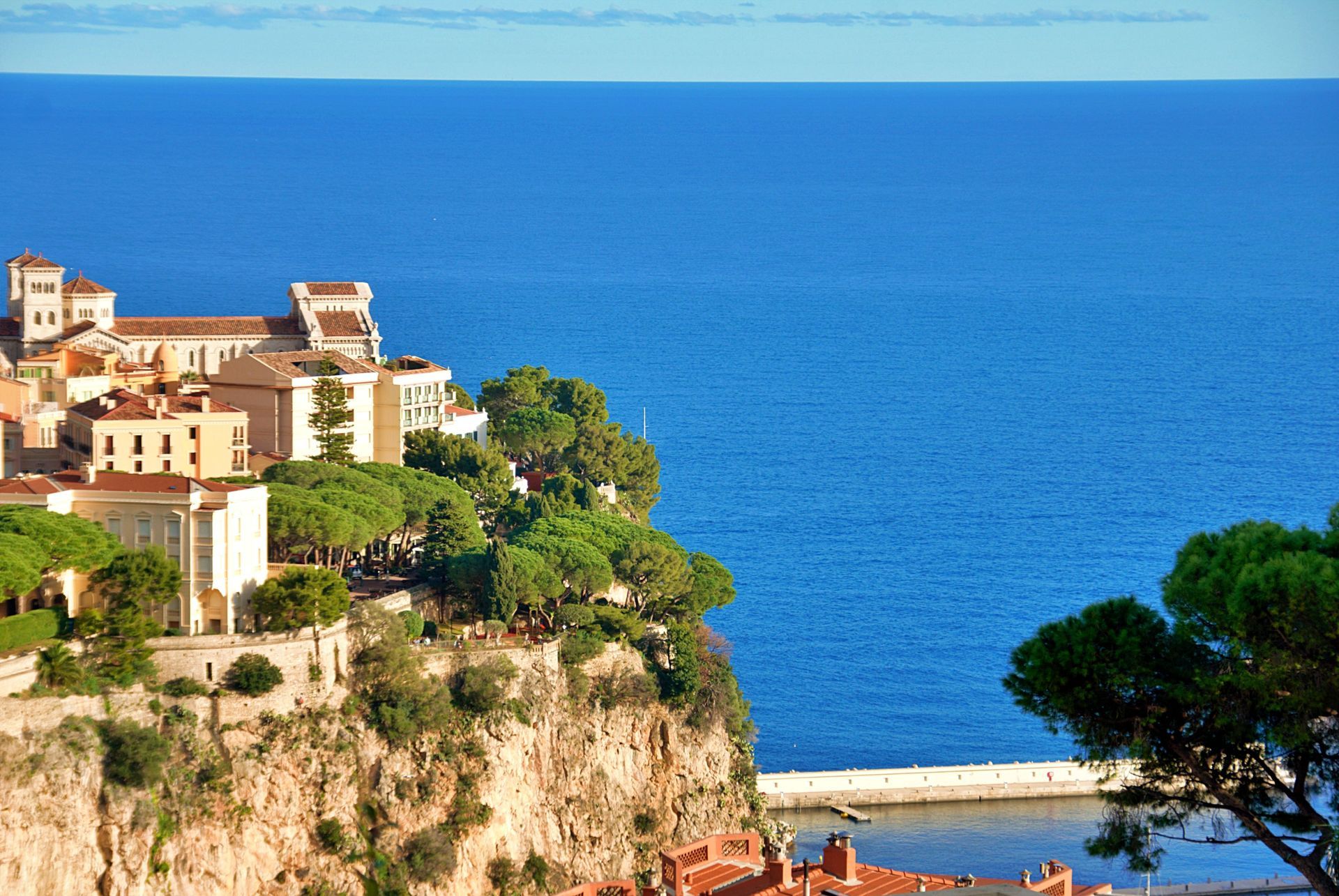 Coastal cliff town with terracotta buildings overlooking a bright blue sea