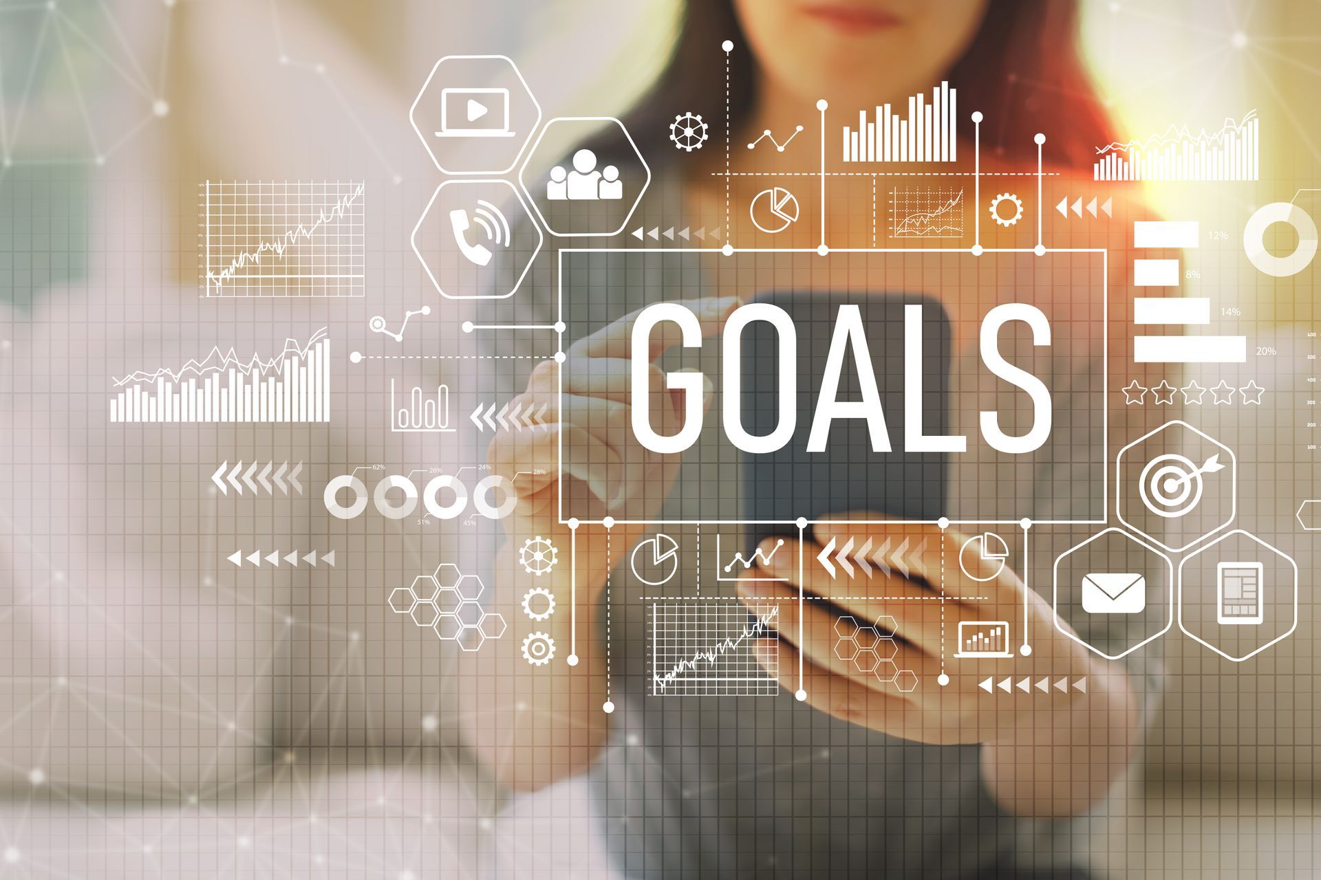 A woman is using a tablet with the word goals written on it.