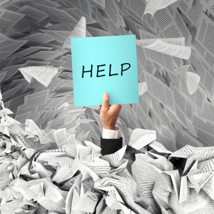 A hand is holding up a sign that says help