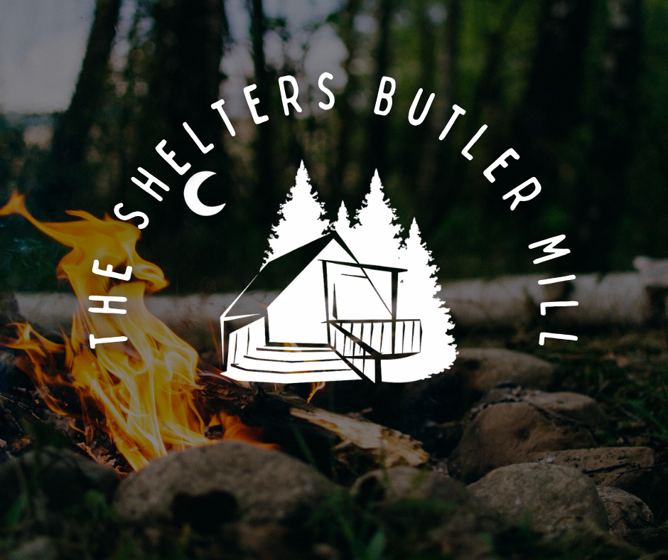 Logo: A cabin silhouette with pine trees and moon, set in front of a campfire.