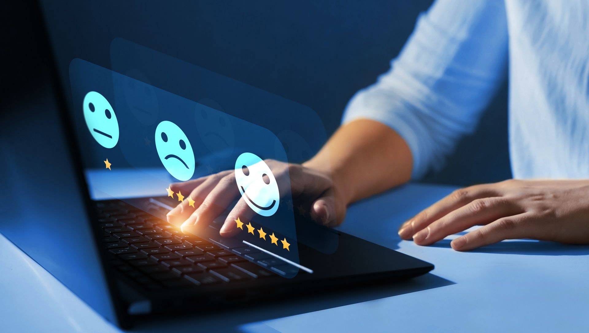 A person is holding a cup of coffee in front of a laptop that says online reviews.