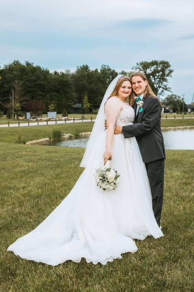 Bride and groom taking photos in cemetery