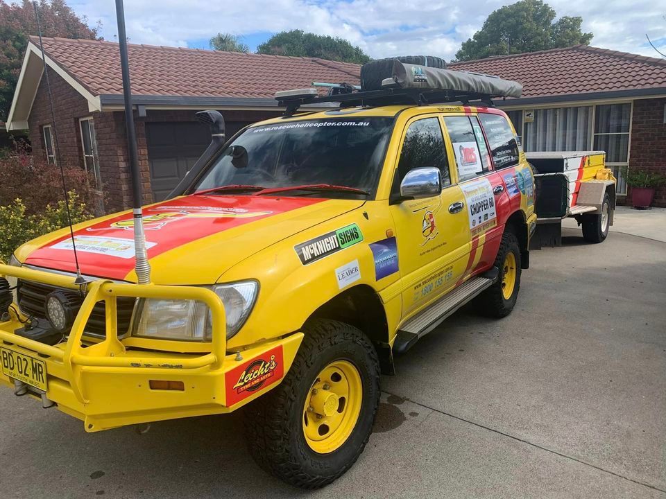 A Yellow and Red Truck Is Parked in Front of A House — Multidrive Parts Australia in Taminda, NSW