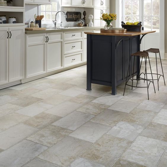 Stone tile in bright kitchen with dark island and barstools