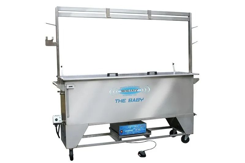 Silver industrial hopper machine on wheels with a blue base and attached frame.