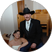 Couple in formal wear; man in cowboy hat and suit, woman in a white strapless dress.