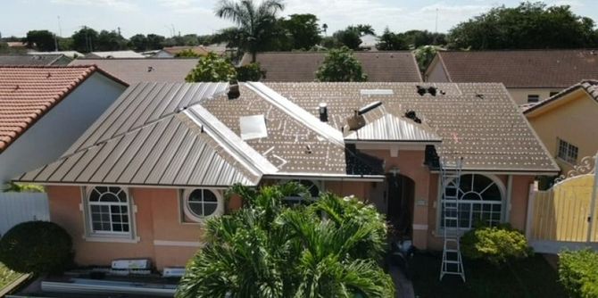 House with a partially replaced roof; the rest of the neighborhood has tile roofs.