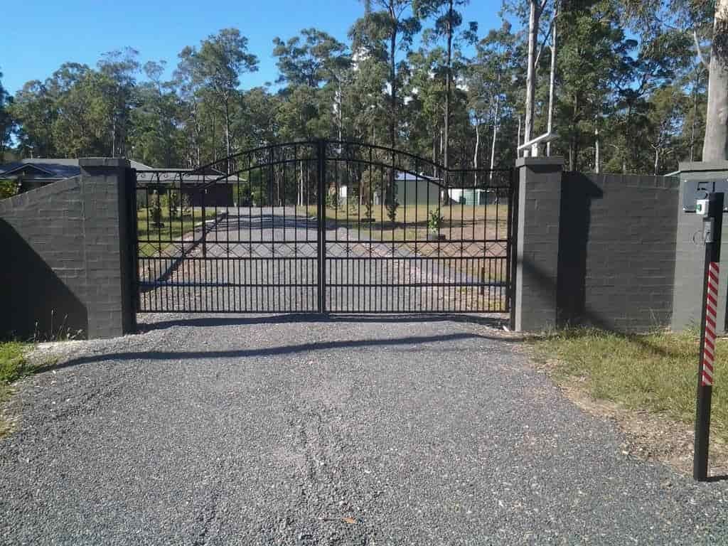 A Metal Gate is Open to a Gravel Road — Riverside Aluminium & Stainless in Coolongolook, NSW