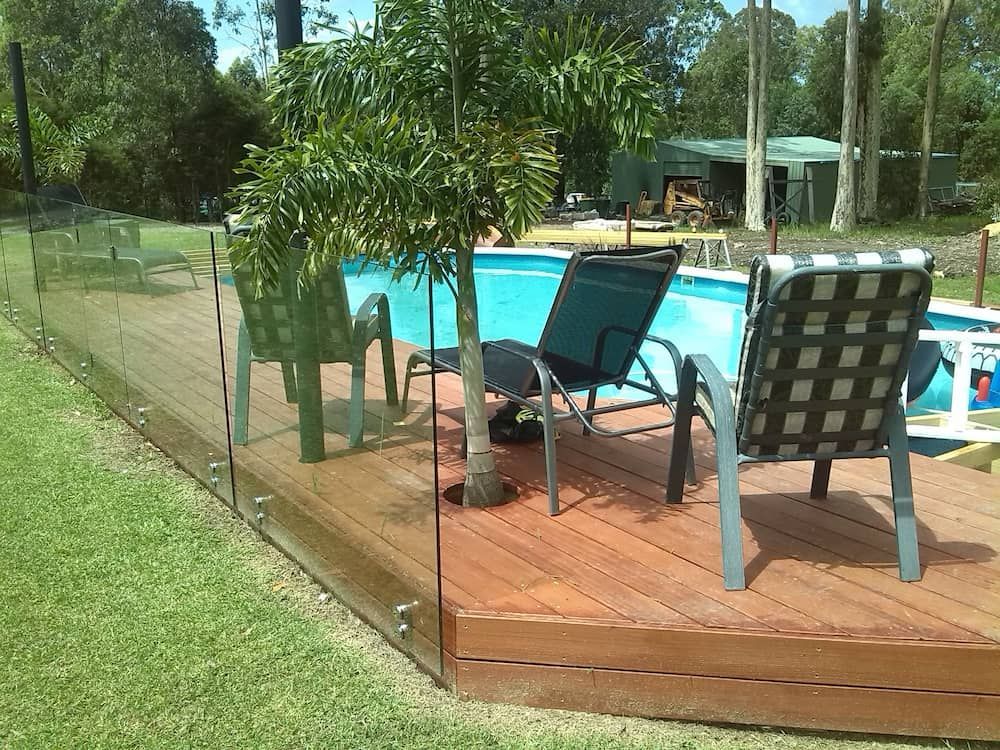 A Deck With Chairs and a Pool in the Background  — Riverside Aluminium & Stainless in Taree, NSW